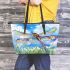 Dragonfly is flying over the grass leather tote bag