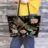 Dragonfly is flying surrounded by flowers leather tote bag