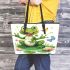 Frog sitting on a lily pad smiling with a butterfly and dragonfly leaather tote bag