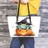 Frog wearing a black witch's hat sitting on top of a halloween pumpkin leaather tote bag