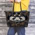 Steampunk panda with top hat and monocle holding golden gears leather tote bag