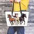 Three horses galloping in the wind leather tote bag