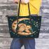 Two cute owls in love sitting on the crescent moon leather tote bag