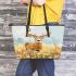 Whitetailed buck standing in a meadow with daisies leather totee bag