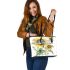 A watercolor illustration of dragonfly with sunflowers leather tote bag
