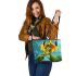 Adorable cartoon frog hanging onto the stem of a sunflower in full bloom leaather tote bag