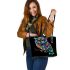 Colorful owl with glowing eyes perched leather tote bag