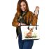 Cute baby deer sitting in the grass leather totee bag