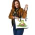 Cute cartoon frog sitting on a lily pad leaather tote bag