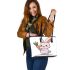 Cute cartoon rabbit holding a carrot leather tote bag