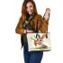 Cute cartoon rabbit holding a carrot leather tote bag