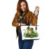 Cute frog sitting on the grass with flowers leaather tote bag