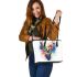 Deer head with colorful watercolor splash behind leather totee bag