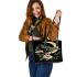 Green dragonflies flying around the moon leather tote bag