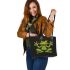Green frog sitting on the ground doing yoga leaather tote bag