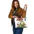 Red and white mushroom with green frog sitting on it leaather tote bag