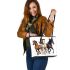 Three horses galloping in the wind leather tote bag