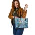 Two cute owls with feathers in shades of blue leather tote bag