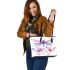 Watercolor dragonfly surrounded in the style of flowers leather tote bag