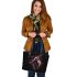 Black background with a colorful horse leather tote bag