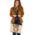 Cute owl wearing glasses and a graduation hat in a simple leather tote bag