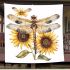 A watercolor illustration of dragonfly with sunflowers blanket