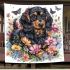 Cute black and tan dachshund among spring flowers with butterflies blanket