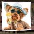 Cute yorkshire terrier in a summer hat and sunglasses holding blanket