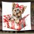 Cute yorkshire terrier inside an open present box blanket