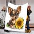 Cute chihuahua puppy with big eyes sitting next to a sunflower blanket