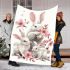 Family of three white rabbits with pink flowers blanket