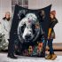 Panda with black and white fur and colorful floral blanket