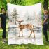 Adorable fawn standing in the snow blanket