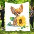 Cute chihuahua puppy with big eyes sitting next to a sunflower blanket