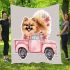 Cute pomeranian dog in a pink truck with flowers blanket