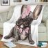 Adorable grey french bulldog puppy wearing pink roses blanket