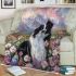 Black and white border collie sits in the foreground amidst blooming flowers blanket