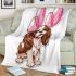 Brown and white king charles spaniel puppy with pink balloons blanket