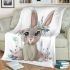 Cute cartoon bunny with big eyes sitting on the flowers blanket