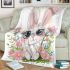 Cute cartoon bunny with big eyes sitting on the flowers blanket