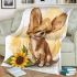 Cute chihuahua puppy with big eyes sitting next to sunflower blanket