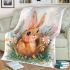 Cute happy baby bunny with big eyes sitting blanket