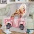 Cute pomeranian dog in a pink truck with flowers blanket