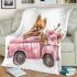 Cute pomeranian dog in a pink truck with flowers blanket