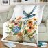 Dragonfly sitting on an open book surrounded by flowers blanket