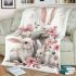 Family of three white rabbits with pink flowers blanket