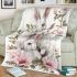 Family of three white rabbits with pink flowers blanket