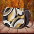 Abstract composition of circles and lines in black saddle bag