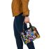 Abstract composition of circular shapes and lines shoulder handbag