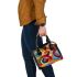 Abstract composition with geometric shapes and vibrant colors shoulder handbag